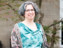 Fran Poodry seated and wearing a teal blouse